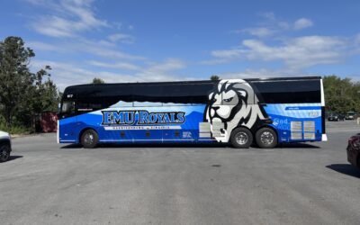 Rolling with Royal Pride: Varsity Travel Teams Up with EMU for a Bold New Bus Wrap